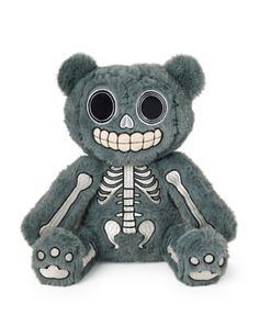 a teddy bear with a skeleton on it's chest and eyes, sitting in front of a white background