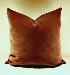 a brown pillow sitting on top of a white table