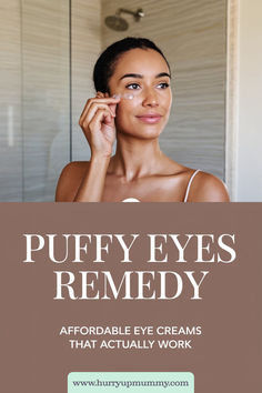 A woman gently applies a hydrating eye cream under her eye in a bathroom, promoting a skincare routine to reduce puffy eyes and achieve a refreshed look. Eye Puffiness Remedies Diy, Under Eye Puffiness Remedies, Eye Cream For Puffy Eyes Bags Diy, Eye Puffiness Remedies, Natural Eye Cream For Puffy Eyes, Tired Eyes Remedy, Doterra Puffy Eye Blend, Eye Medicine, Eye Health Remedies