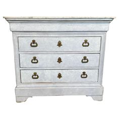 an old white dresser with gold handles and knobs on the drawers is isolated against a white background