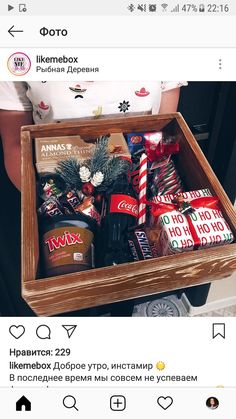 a wooden box filled with assorted candy and candies on top of a table