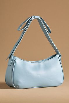 Exclusively at Anthropologie Polyurethane; polyester lining One inner slip pocket One inner zip pocket Zipper closure Imported | x Anthropologie Bow Shoulder Bag by Mali + Lili in Blue, Women's, Polyester/Polyurethane Bow Purse, Silk Purse, Blue Pumpkins, Bow Bag, Perfect Handbag, Blue Purse, Unique Bags