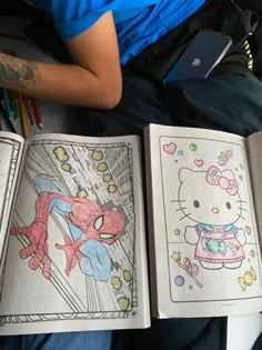 two children's coloring books with hello kitty and spiderman on them, sitting next to each other