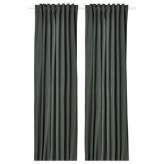 two dark green curtains hanging on a white wall