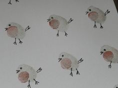 a close up of a paper with birds drawn on it's sides and feet