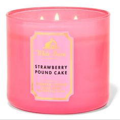 a pink candle that is sitting in front of a white background with the words strawberry pound cake on it