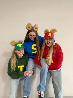 three girls in costumes posing for the camera