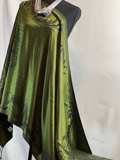 Indulge in the beautiful Green Pashmina Shawl with Dark Green Floral Detail - Timeless Fringed Wrap. This piece exudes elegance and classic design, with a lush emerald green backdrop and intricate dark green floral detailing. The dimensions of 71.00x28.00 inches make it a versatile choice for various styles and provide ample coverage.  Crafted from luxurious pashmina fabric, known for its softness and warmth, this shawl is the perfect companion for any season. Its lightweight nature makes it suitable for multiple occasions, whether you wear it as a traditional shawl over an evening dress or stylishly draped around your neck for chilly days.  The elegant fringe finishing adds a touch of sophistication to the shawl's rich appearance and texture. It's a statement piece that is both fashionabl Fancy Shawl Regalia, Green Shawl, Evening Wraps, Floral Shawl, Fringe Scarf, Pashmina Shawl, Pashmina Scarf, Shawls And Wraps, Stylish Accessories