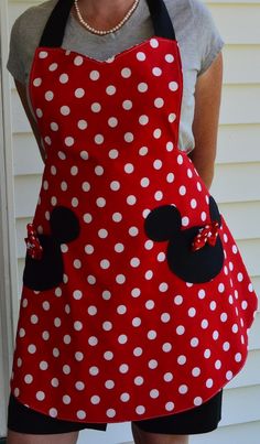 a woman wearing an apron made to look like minnie mouse