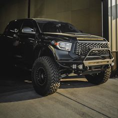 a black truck parked in front of a building