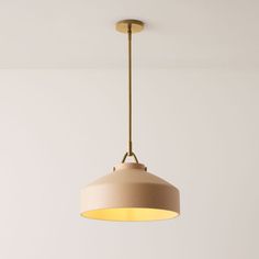 a light fixture hanging from the ceiling in a room with white walls and flooring