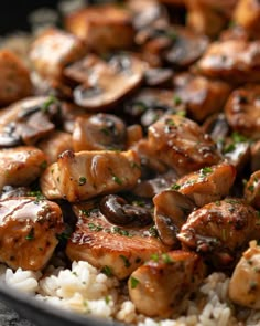 chicken and mushrooms are served over rice in a skillet