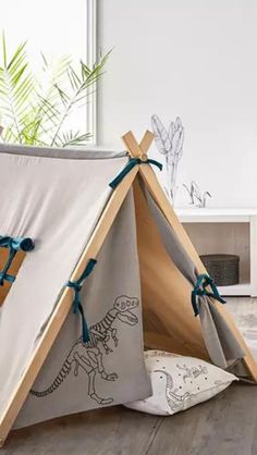 a child's teepee with dinosaurs on it