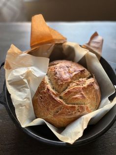 a loaf of bread sitting in a pan on top of a table