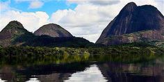 the mountains are reflected in the still water