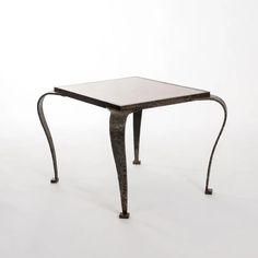 a small metal table with a glass top on it's legs, against a white background