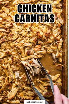 a pan filled with chicken carnitas next to a hand holding a knife and fork