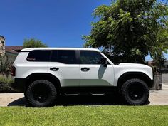 a white truck parked in front of a house