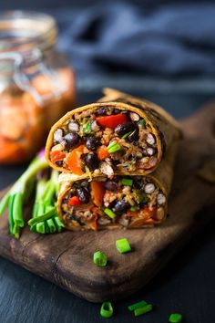 a wrap with beans, carrots and celery on a wooden cutting board