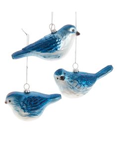 two blue glass birds hanging from chains