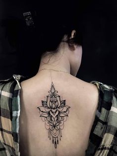 the back of a woman's neck with a tattoo on it