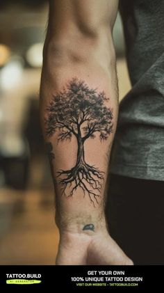 a man's arm with a tree tattoo on it