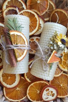 orange slices are wrapped in twine and tied with twine, surrounded by dried flowers