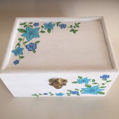 a white box with blue flowers painted on it