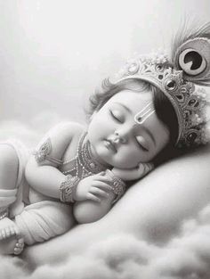 a black and white photo of a baby wearing a tiara sleeping on a cloud