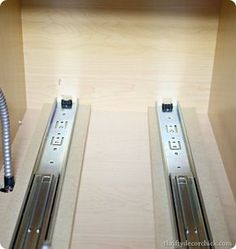 two stainless steel turnsticks on top of a wooden shelf with a vacuum in the middle