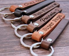 four leather keychains with personalized names on them