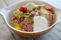 a bowl filled with different ingredients on top of a wooden table