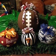 three decorated footballs are sitting in the grass