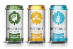 three cans of lakewood beer are shown in this image, one is green and the other is blue