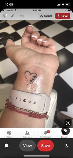 a person with a heart tattoo on their wrist