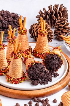 several cones made out of cookies and chocolate on a plate