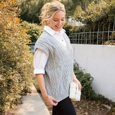 The Anna-Kaci Women's Cable Knit Sweater Vest with V-Neck is a stylish and versatile addition to your wardrobe. Crafted from soft, cozy fabric, this sleeveless pullover top features a classic cable knit design and a flattering V-neckline. Perfect for layering, it can be worn over a blouse or long-sleeve shirt for a chic, preppy look, or on its own for a more casual vibe. Ideal for transitioning between seasons, this sweater vest pairs effortlessly with jeans, skirts, or tailored pants. Perfect f Casual V-neck Cable Knit Sweater Vest, Gray V-neck Sweater Vest For Spring, Casual Sleeveless V-neck Sweater For Fall, Casual Cable Knit Sleeveless Tank Top, Casual Cable Knit Sweater Vest For Spring, Spring Casual Cable Knit Sweater Vest, Spring V-neck Sweater Vest, Sleeveless Fall Sweater Vest, Casual V-neck Sweater Vest For Fall