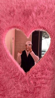 a man in a pink heart shaped frame