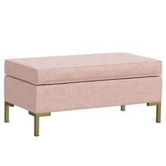 a pink ottoman sitting on top of a wooden frame