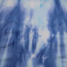 blue and white tie dyed fabric with clouds in the background