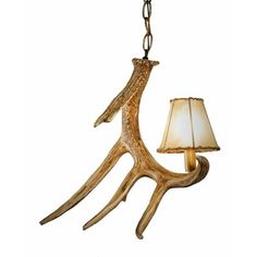 an antler lamp hanging from a chain with a light on it's side