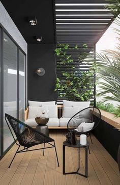 an outdoor living area with black and white furniture