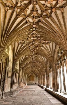 the inside of an old building with stone floors and vaulted ceilings, along with columns and arches