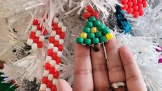 a person holding a christmas tree made out of candy canes in their palm hand