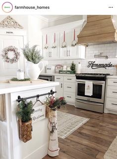 a kitchen with white cabinets and christmas decorations