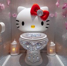 a hello kitty toilet in a bathroom decorated with pink and silver glitters, surrounded by candles