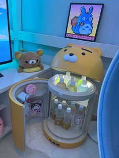 a computer desk with a teddy bear sitting on top of it next to a monitor