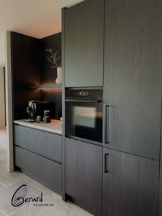 a kitchen with black cabinets and white counter tops