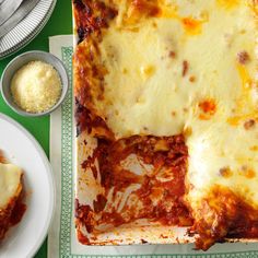 two plates with lasagna on them, one has cheese and the other has sauce