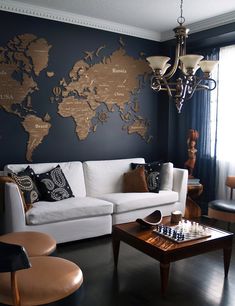 a living room filled with furniture and a world map on the wall